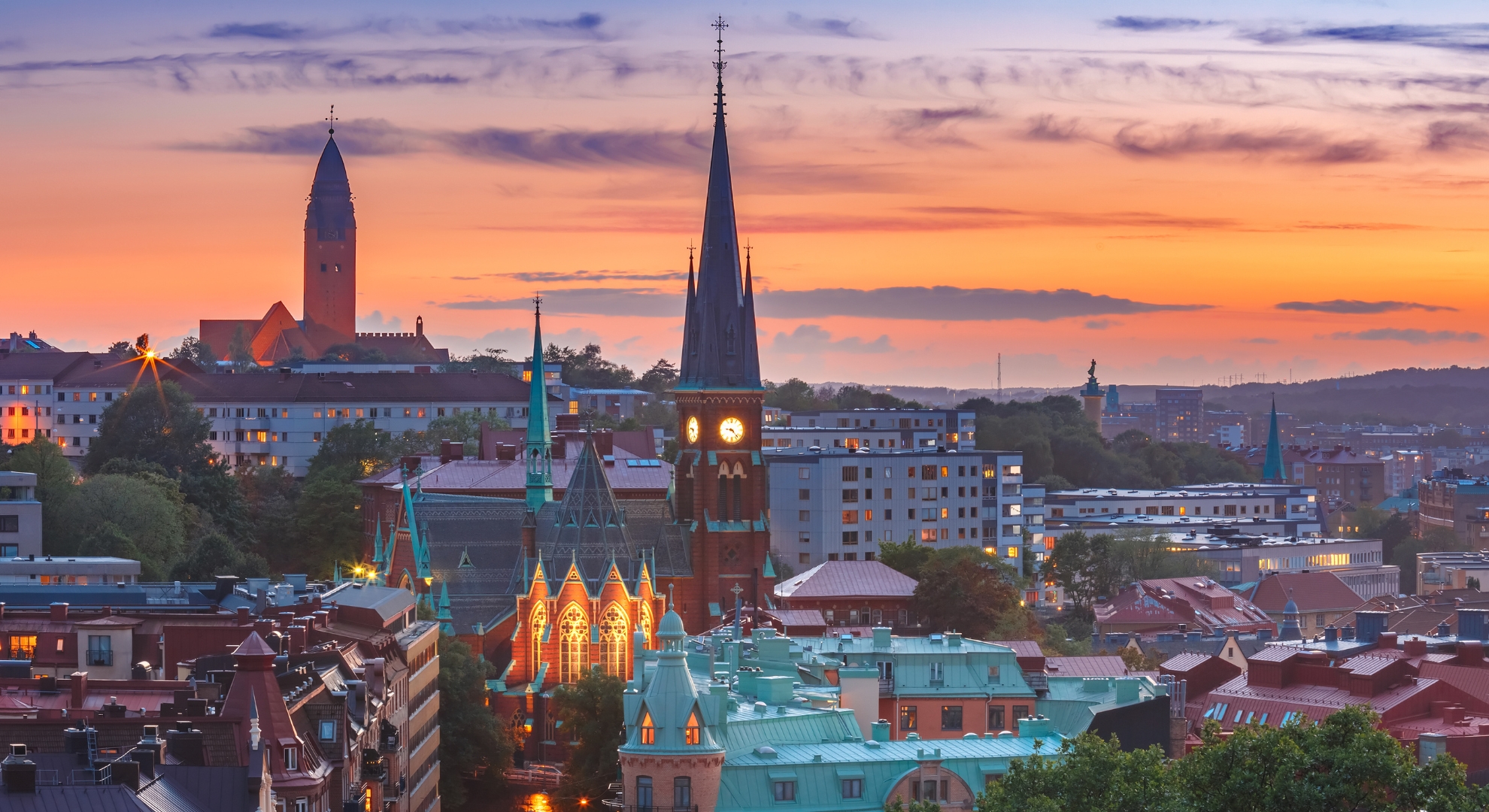 A picturesque sunset in Riga, Latvia, highlighting the city's architecture against a vibrant sky.