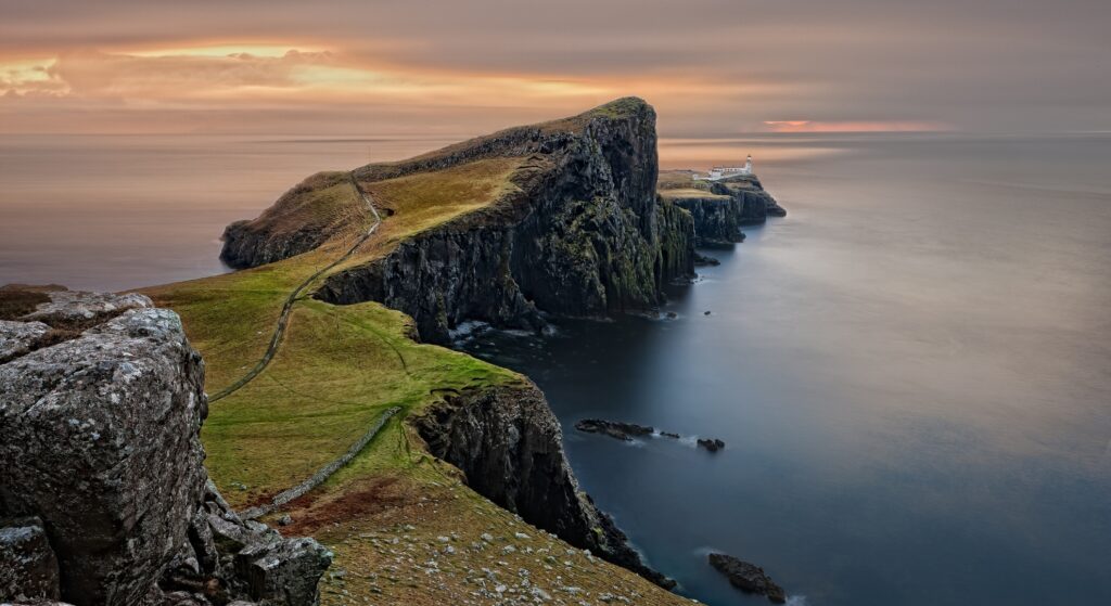 Sunset over the Isle of Skye, showcasing vibrant colors reflecting on the water in the United Kingdom.