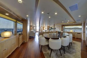 Interior of luxury yacht M/Y GRANDE AMORE featuring an elegant dining table set for a lavish meal.
