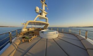 The deck of the luxury yacht M/Y GRANDE AMORE featuring a hot tub and elegant outdoor seating.