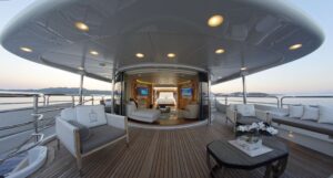 Luxurious interior of the M/Y GRANDE AMORE yacht, highlighting a spacious deck area with stylish decor and amenities.