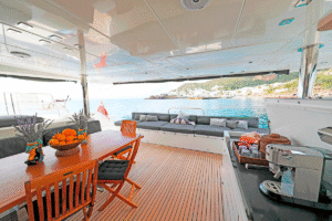 Interior of super yacht S/Y KASKAZI FOUR featuring an elegant dining table with chairs in a luxurious setting.