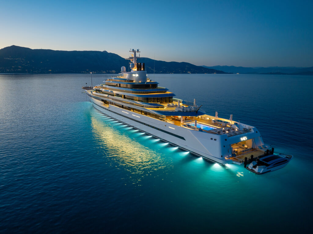 GIGA YACHT cruising serenely at night with up to 16 guests catered for by up to 39 superyacht crew in the Mediterranean
