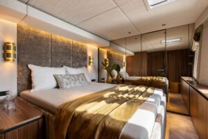 Spacious and comfortable master suite aboard the SUNREEF 80 NALANI yacht, featuring elegant furnishings and ample natural light.