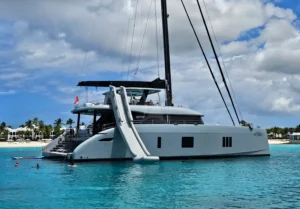 Sunreef 80 ''Shades of Grey'' getting her slide and water toys ready at anchorage in Balearics